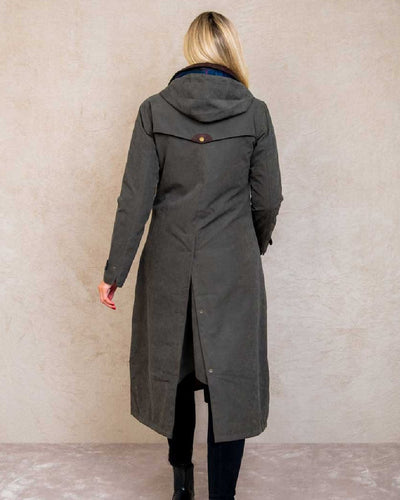 Olive coloured Jack Murphy Erin Long Waterproof Coat on wall background #colour_olive