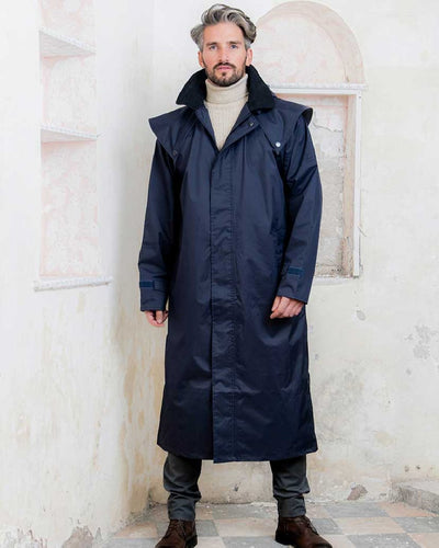 Navy coloured Jack Murphy Lambourne Mens Long Bush Coat on wall background #colour_navy