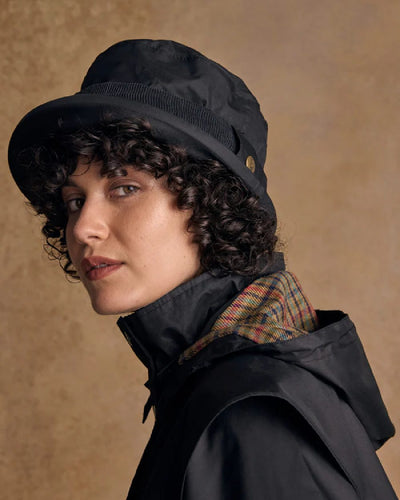 Black coloured Jack Murphy Malvern Heritage Rain Hat on wall background #colour_black