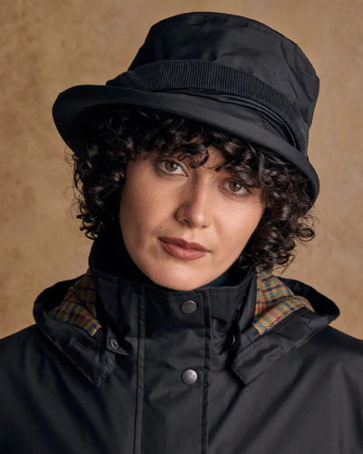 Black coloured Jack Murphy Malvern Heritage Rain Hat on wall background #colour_black