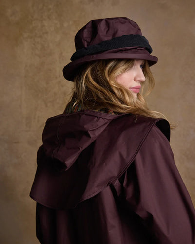 Deep Claret coloured Jack Murphy Malvern Heritage Rain Hat on wall background #colour_deep-claret