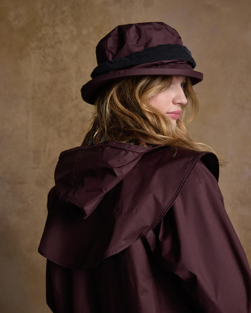 Deep Claret coloured Jack Murphy Malvern Heritage Rain Hat on wall background 