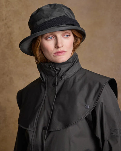 Olive coloured Jack Murphy Malvern Heritage Rain Hat on wall background #colour_olive