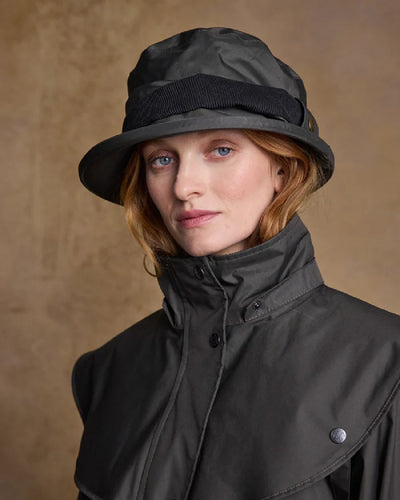 Olive coloured Jack Murphy Malvern Heritage Rain Hat on wall background #colour_olive