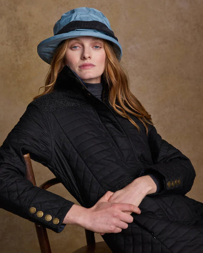 Smoke Blue coloured Jack Murphy Malvern Heritage Rain Hat on wall background #colour_smoke-blue