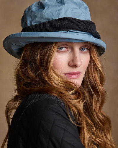 Smoke Blue coloured Jack Murphy Malvern Heritage Rain Hat on wall background #colour_smoke-blue