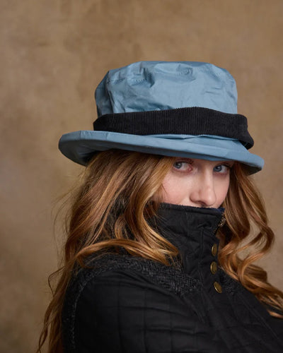 Smoke Blue coloured Jack Murphy Malvern Heritage Rain Hat on wall background #colour_smoke-blue