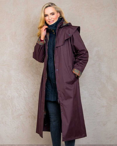 Deep Claret coloured Jack Murphy Malvern Ladies Waterproof Bush Coat on wall background #colour_deep-claret