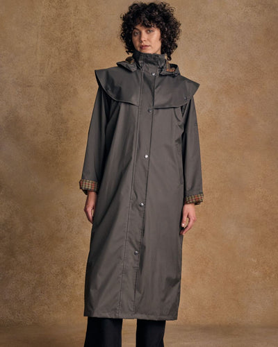 Olive coloured Jack Murphy Malvern Ladies Waterproof Bush Coat on wall background #colour_olive