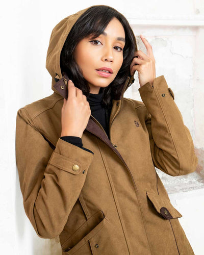 Camel coloured Jack Murphy Una 3/4 Waterproof Coat on wall background #colour_camel