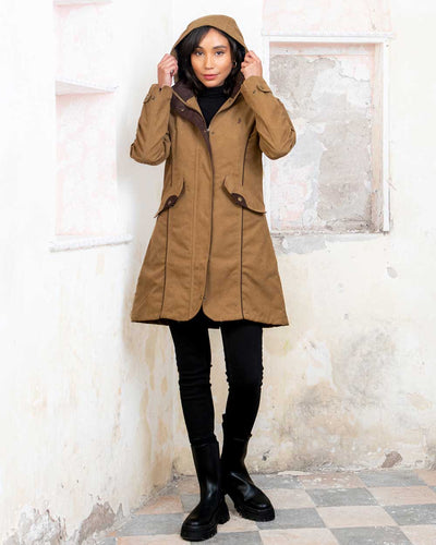 Camel coloured Jack Murphy Una 3/4 Waterproof Coat on wall background #colour_camel