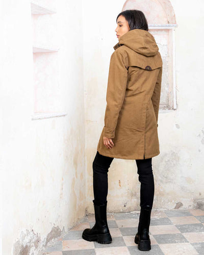 Camel coloured Jack Murphy Una 3/4 Waterproof Coat on wall background #colour_camel