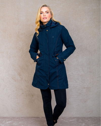 Heritage Navy coloured Jack Murphy Una 3/4 Waterproof Coat on wall background #colour_heritage-navy