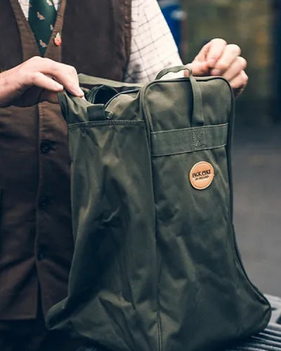 Green coloured Jack Pyke Boot Bag on blurry background #colour_green