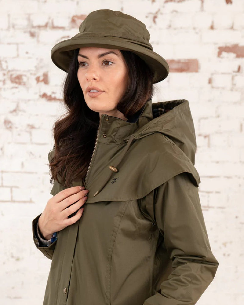 Fern coloured Lighthouse Canterbury Waterproof Hat on wall background 