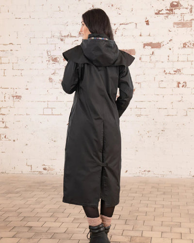 Black Lighthouse Outback Full Length Ladies Waterproof Raincoat on wall background #colour_black