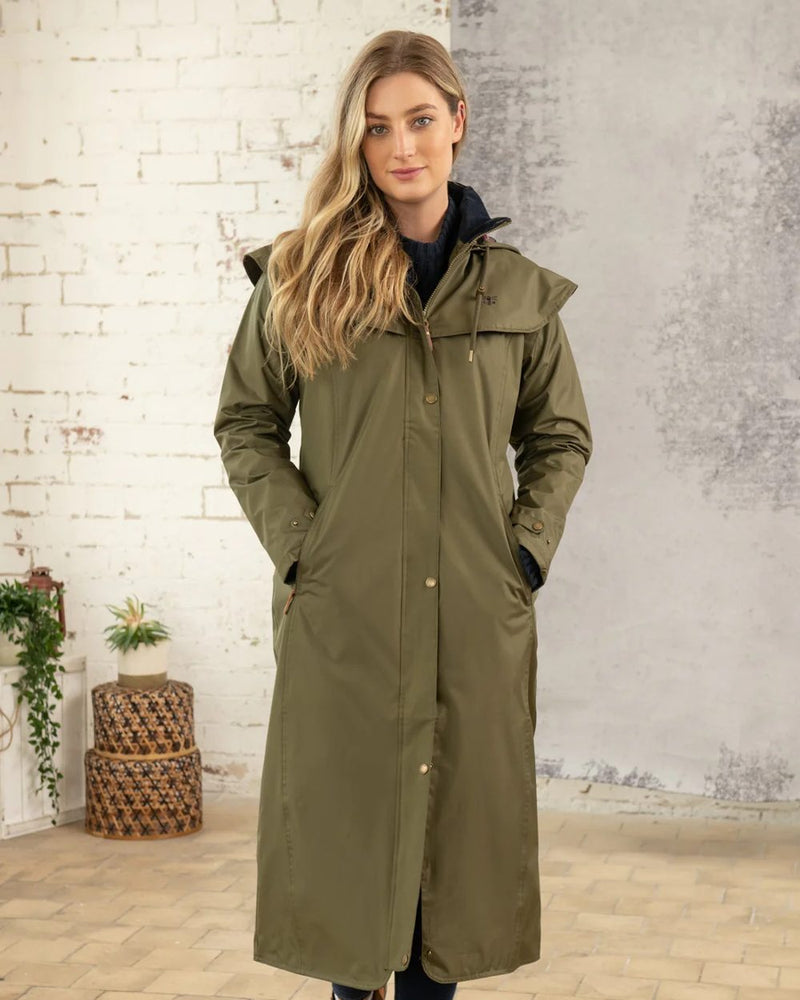 Fern Lighthouse Outback Full Length Ladies Waterproof Raincoat on wall background 