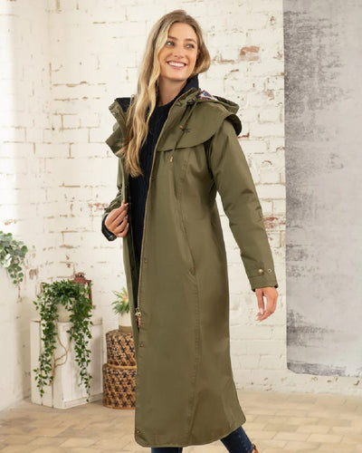 Fern Lighthouse Outback Full Length Ladies Waterproof Raincoat on wall background #colour_fern