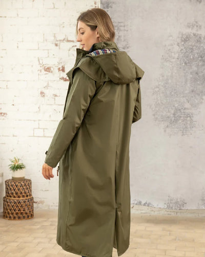 Fern Lighthouse Outback Full Length Ladies Waterproof Raincoat on wall background #colour_fern