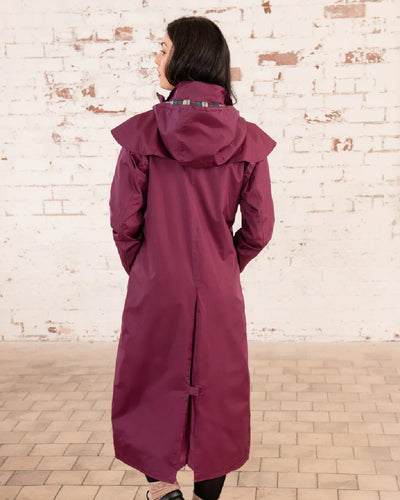 Plum coloured Lighthouse Outback Full Length Ladies Waterproof Raincoat on wall background #colour_plum