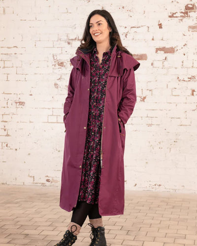 Plum coloured Lighthouse Outback Full Length Ladies Waterproof Raincoat on wall background #colour_plum