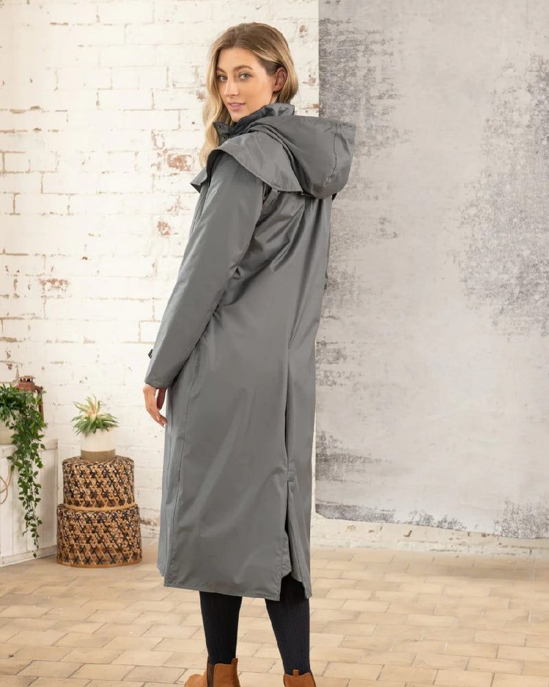 Urban Grey Lighthouse Outback Full Length Ladies Waterproof Raincoat on wall background 