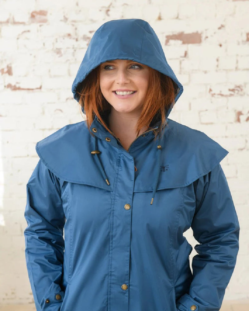 Deep Sea coloured Lighthouse Outrider 3/4 Length Ladies Waterproof Raincoat on wall background 