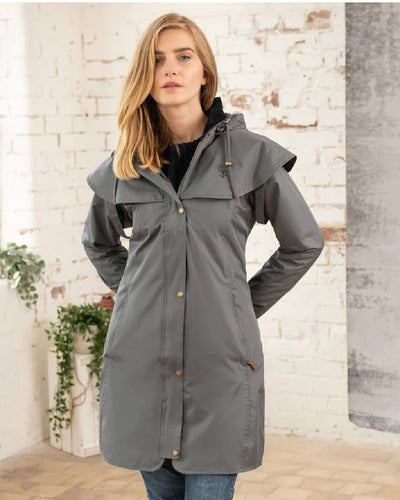 Urban Grey coloured Lighthouse Outrider 3/4 Length Ladies Waterproof Raincoat on wall background #colour_urban-grey