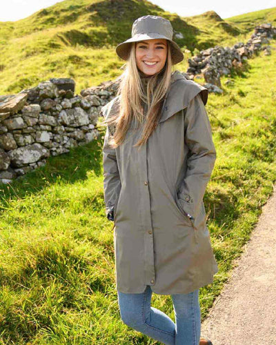 Urban Grey coloured Lighthouse Outrider 3-4 Length Ladies Waterproof Raincoat - Clearance Colours on grassy background #colour_urban-grey