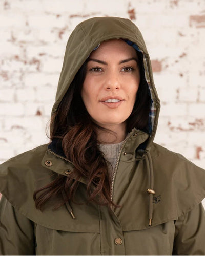 Fern coloured Lighthouse Outrider 3/4 Length Ladies Waterproof Raincoat on wall background #colour_fern