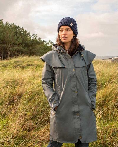 Urban Grey coloured Lighthouse Outrider 3-4 Length Ladies Waterproof Raincoat - Clearance Colours on grass background #colour_urban-grey