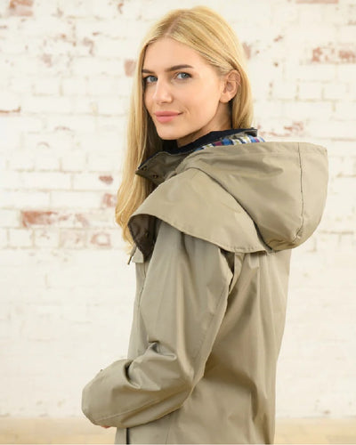 Fawn coloured Lighthouse Outrider 3/4 Length Ladies Waterproof Raincoat on white background #colour_fawn