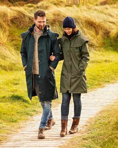 Navy coloured Lighthouse Long Waterproof Coat on wood walk background #colour_navy