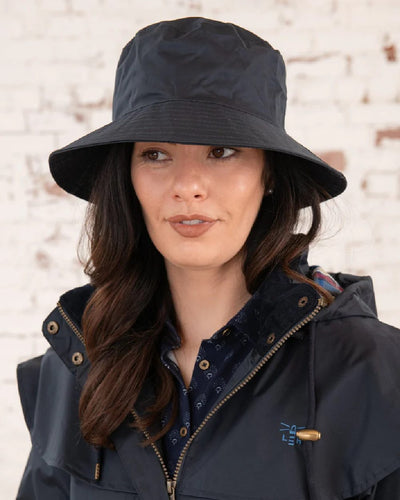 Nightshade coloured Lighthouse Storm Waterproof Hat on wall background #colour_nightshade