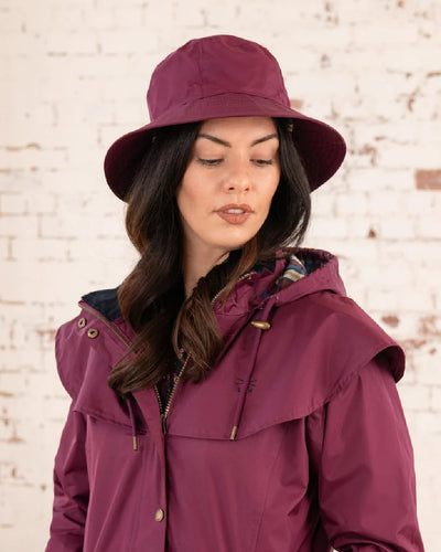 Plum coloured Lighthouse Storm Waterproof Hat on wall background #colour_plum