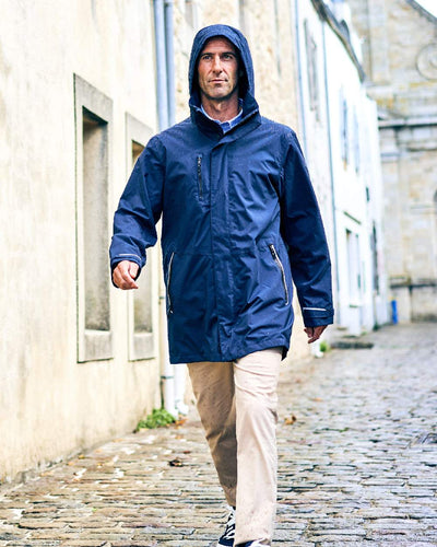 Navy coloured Musto Sardinia Long Rain Jacket on wall background #colour_navy