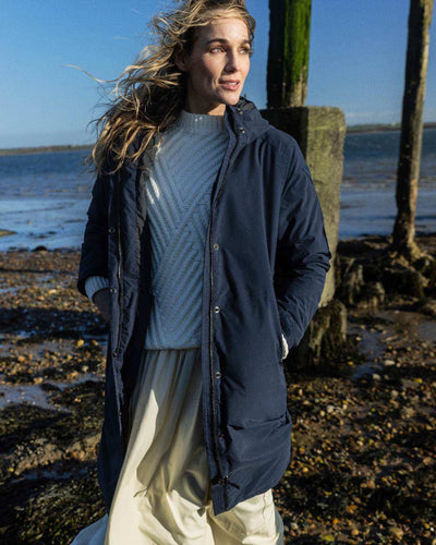 Navy coloured Musto Womens Corsica Primaloft Longline Parka on sea background #colour_navy