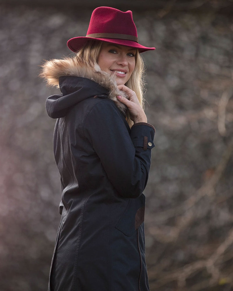 Navy Coloured Alan Paine Fernley Long Waterproof Coat On A Backyard Background 