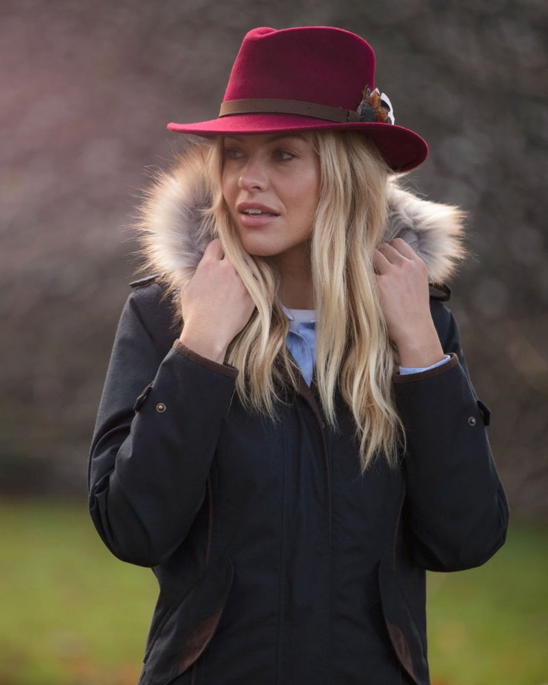 Navy Coloured Alan Paine Fernley Long Waterproof Coat On A Backyard Background 