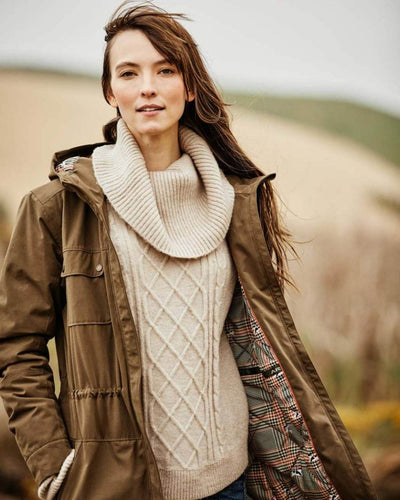 Earth Coloured Ariat Womens Argentium Waterproof Parka On A blurry Background #colour_earth