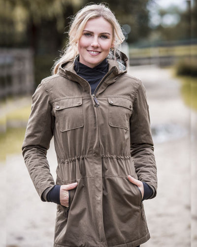 Earth Coloured Ariat Womens Argentium Waterproof Parka On A Blurry Background #colour_earth