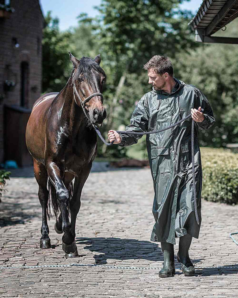 Green Khaki Coloured Baleno Montana Long Raincoat On A Stable Background 