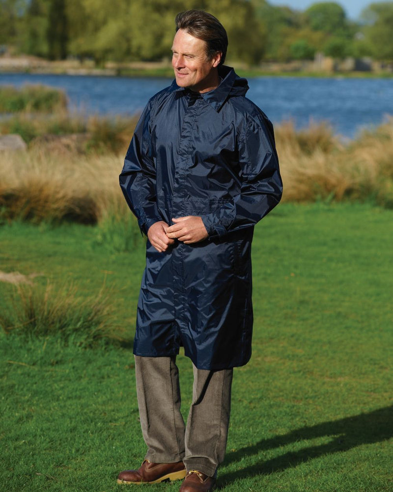 Navy Coloured Champion Storm Long Waterproof Coat On A Countryside Background