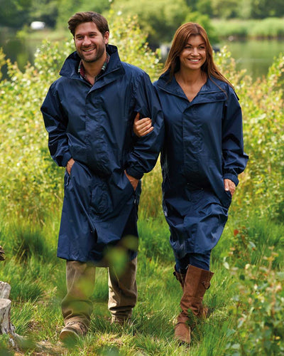 Navy Coloured Champion Storm Long Waterproof Coat On A Countryside Background