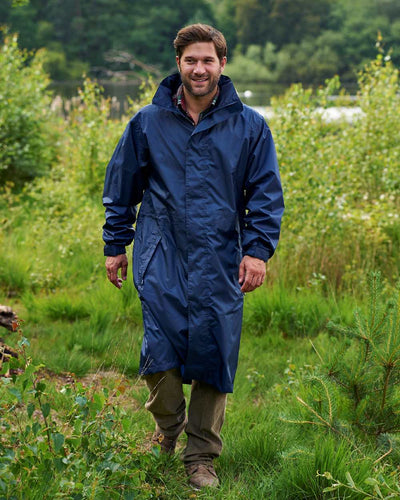 Navy Coloured Champion Storm Long Waterproof Coat On A Countryside Background