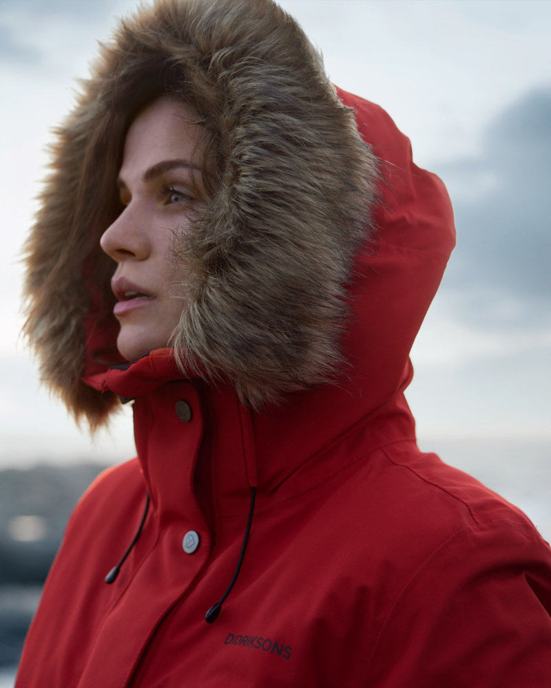 Pomme Red Coloured Didriksons Erika Ladies Padded Waterproof Parka 3 On A Coastal Background 