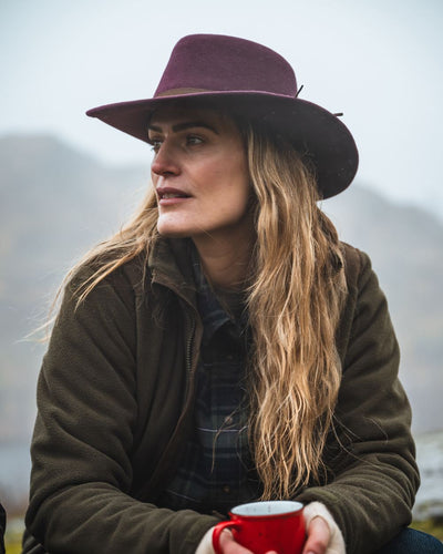 Merlot Coloured Hoggs Of Fife Perth Crushable Felt Hat On model with sky Background #colour_merlot