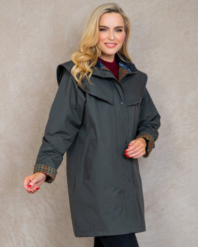 Olive coloured Jack Murphy Cotswold Ladies Waterproof 3/4 Coat on wall background #colour_olive