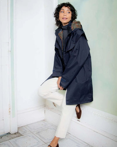 Heritage Navy coloured Jack Murphy Cotswold Ladies Waterproof 3/4 Coat on wall background #colour_heritage-navy