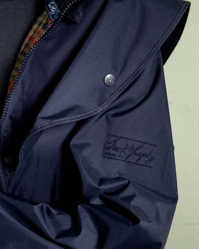 Heritage Navy coloured Jack Murphy Cotswold Ladies Waterproof 3/4 Coat on wall background #colour_heritage-navy